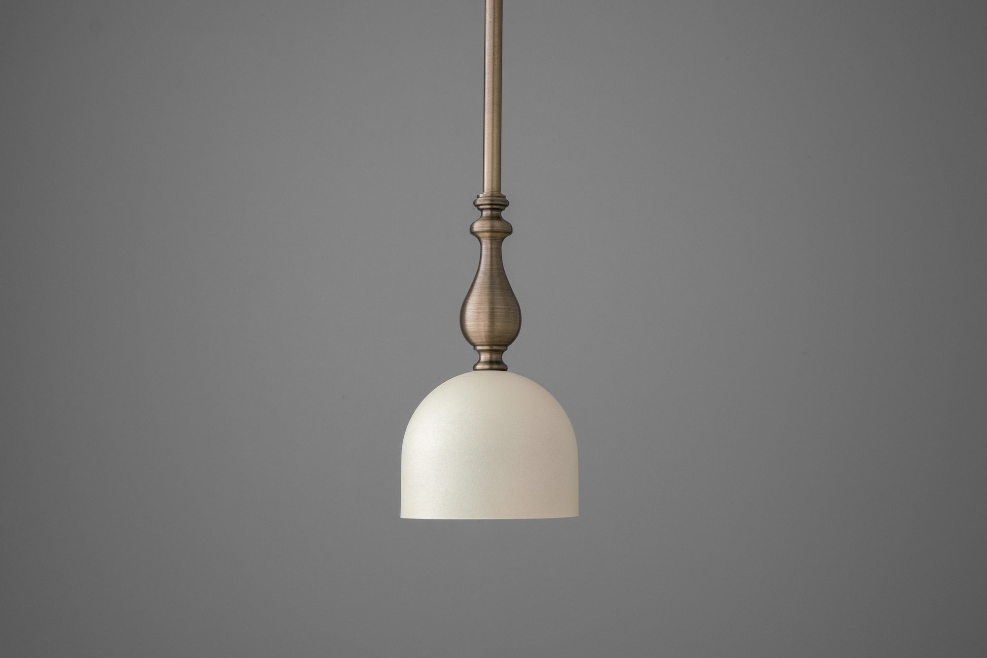 Antique brass deep ball pendant with cream dome shade hanging from matching rod. - PENDANT MODEL N0. 6780