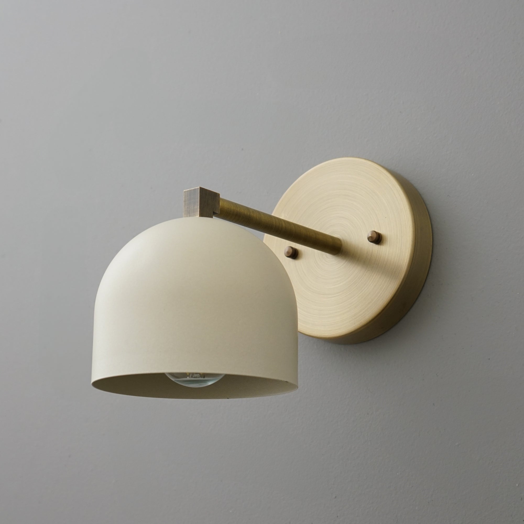 Antique brass wall sconce with cream dome-shaped shade and round backplate. - SCONCE MODEL NO. 3622