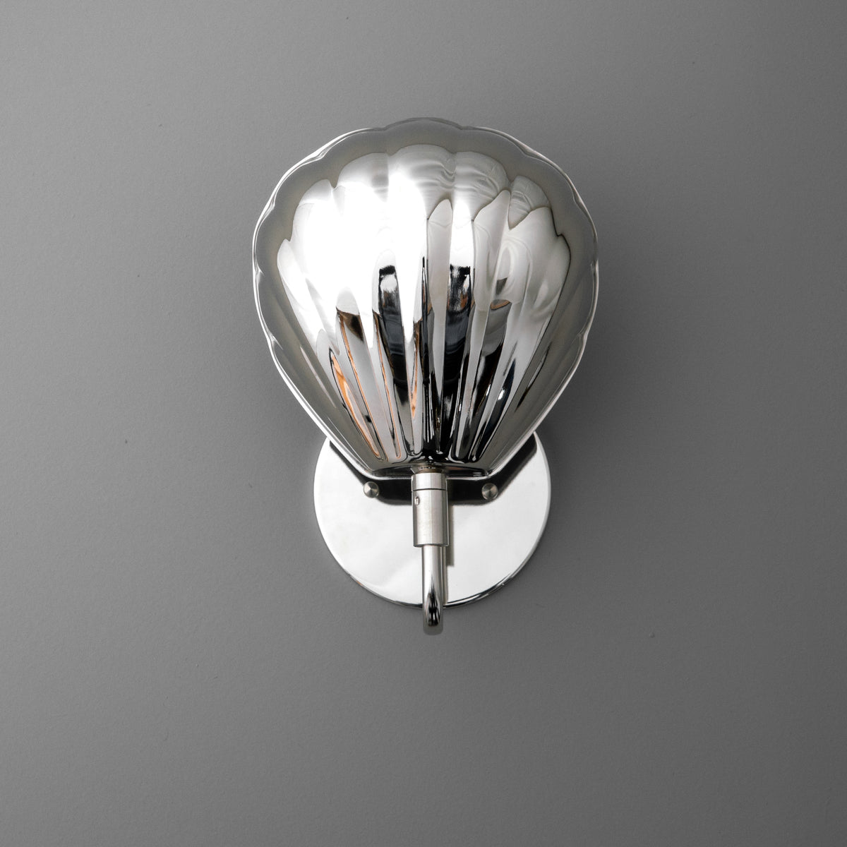 Chrome-plated metal wall sconce with a scalloped, shell-shaped shade and round backplate. - SCONCE MODEL NO. 1086