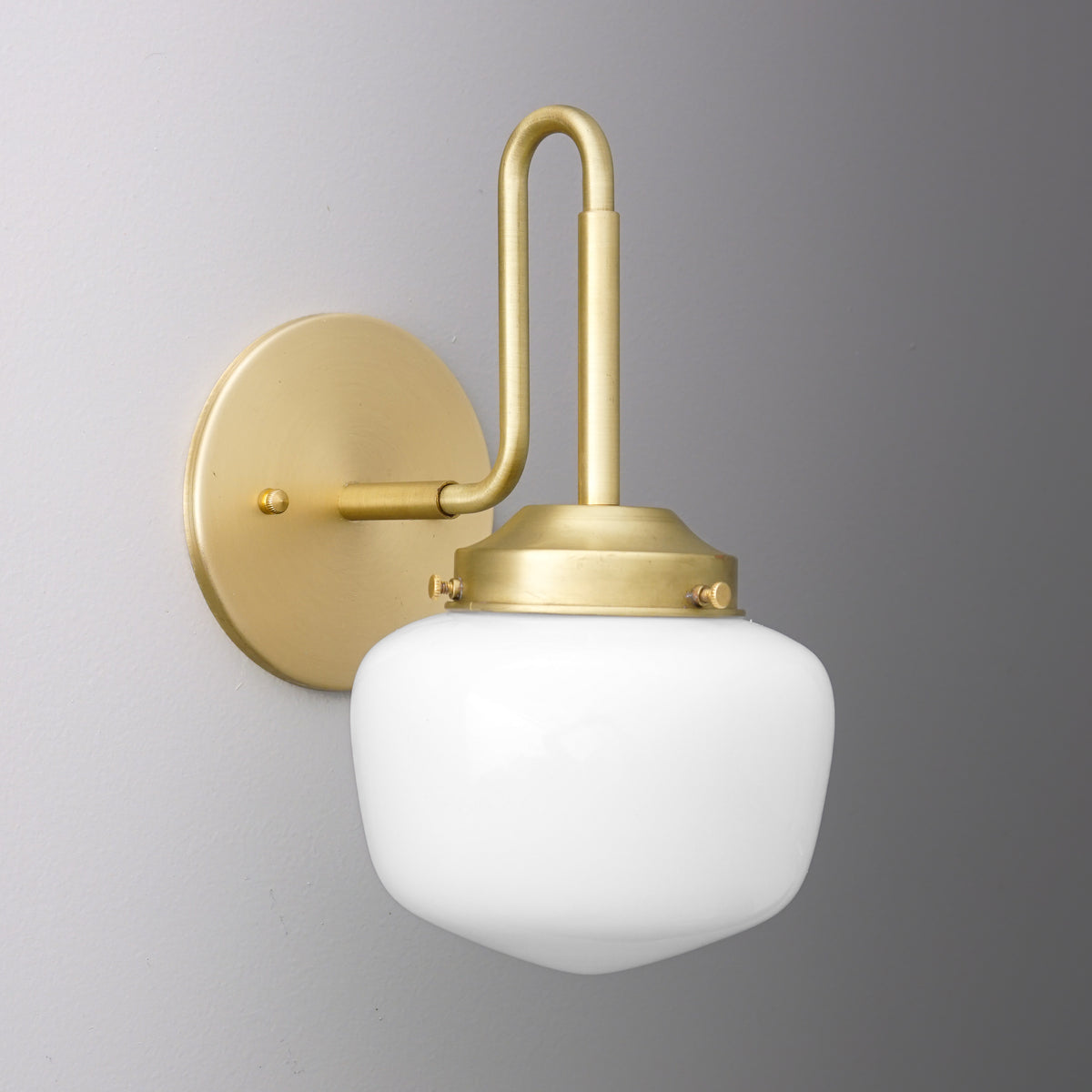 Wall-mounted sconce with matte gold metal fixture and rounded white glass shade. - SCONCE MODEL NO. 1020