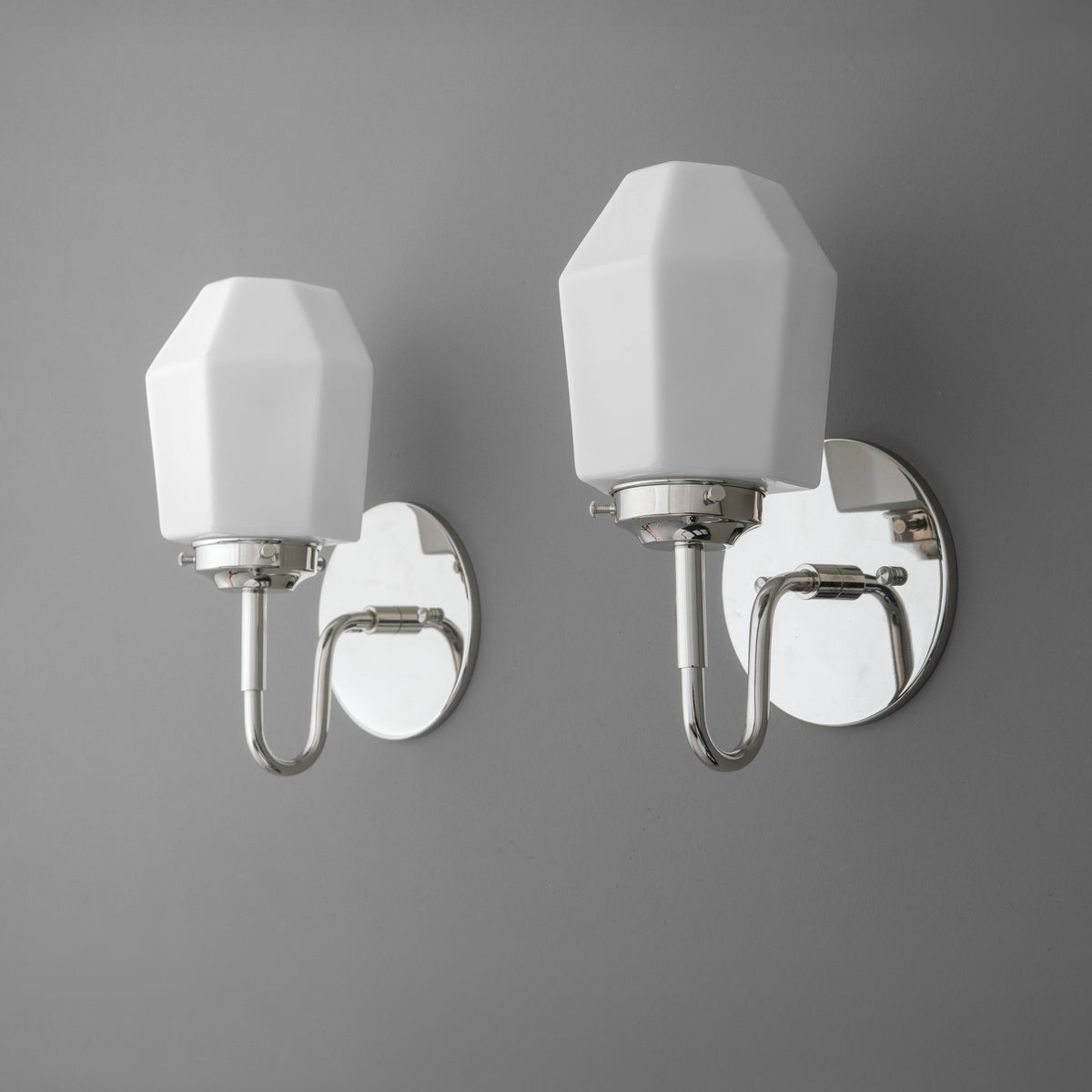 Pair of chrome 1-bulb wall sconces with faceted white glass shades and oval backplates. - SCONCE MODEL NO. 1038