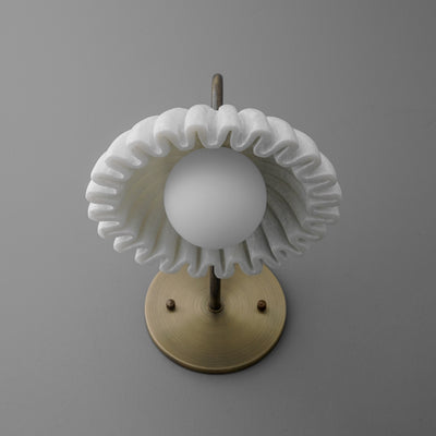 Wall sconce with antique brass base and spherical white glass shade surrounded by pleated white fabric ring. - SCONCE MODEL NO. 2782