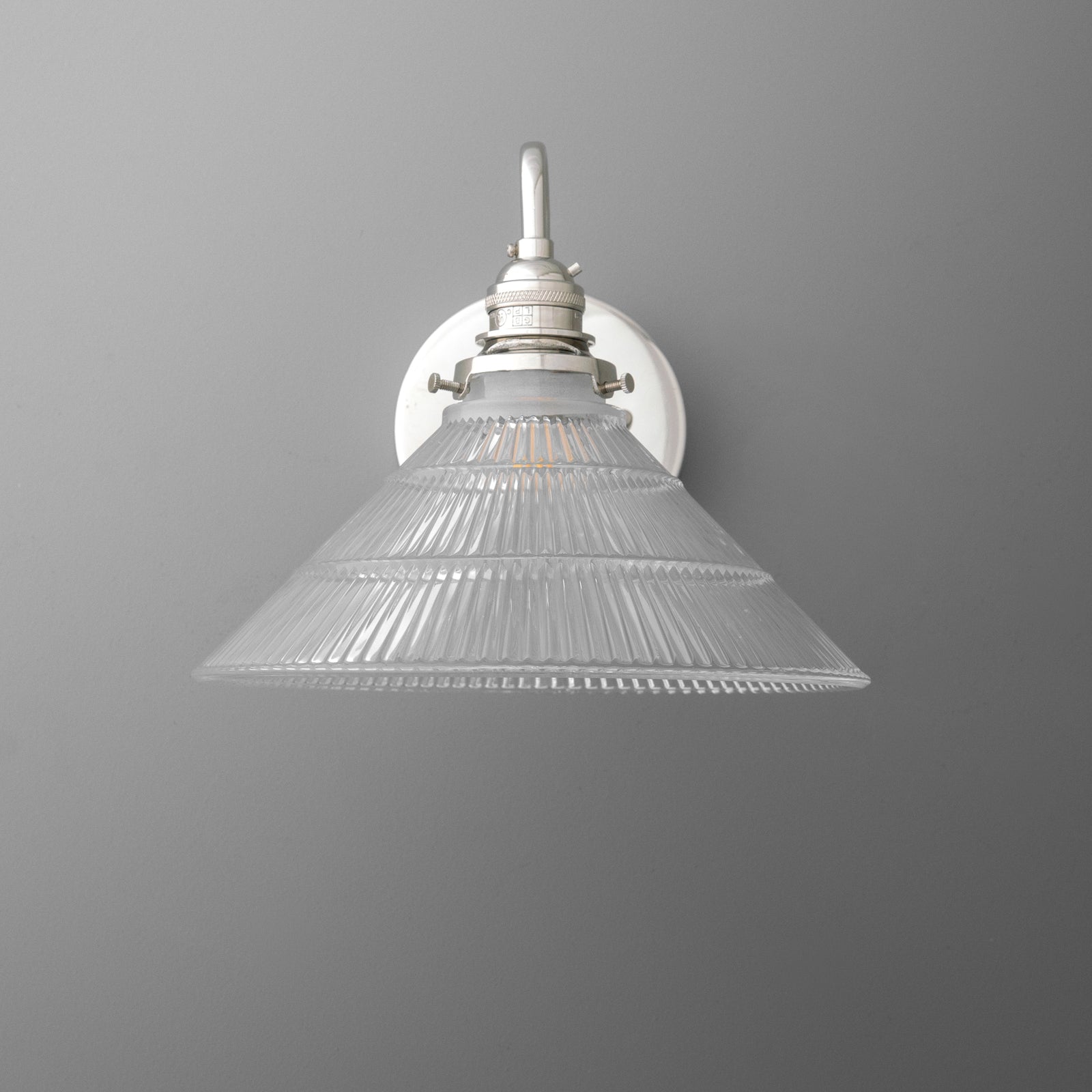 Wall-mounted single-bulb sconce with clear ribbed glass conical shade and white metal fixture. - SCONCE MODEL NO. 4703