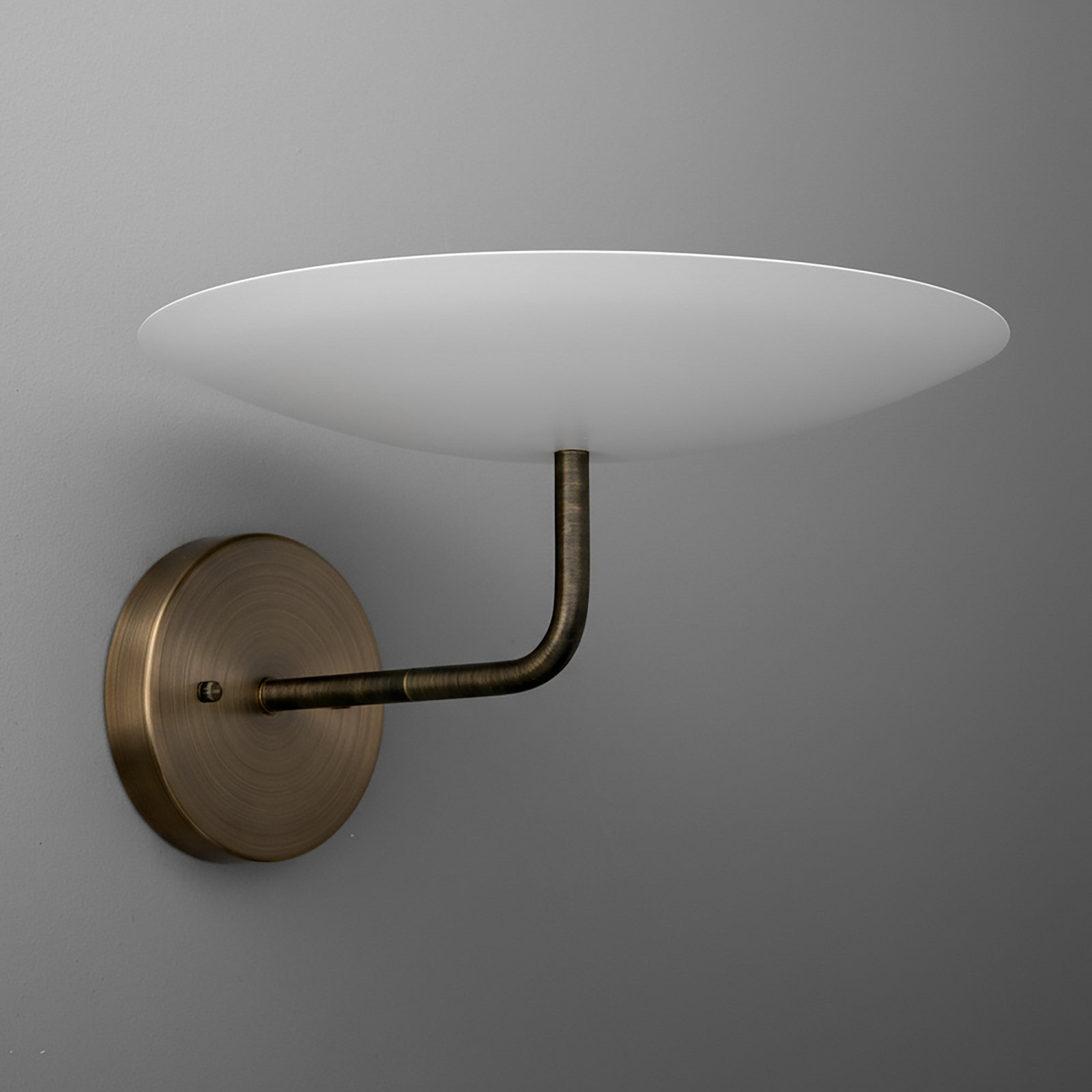 Wall sconce with three white opaque round shades and antique brass curved arm and base. - SCONCE MODEL NO. 1504