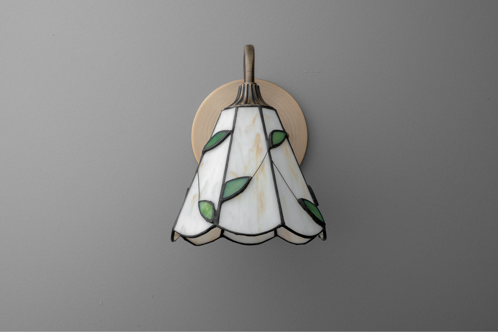 Stained glass sconce with white and green leaf design and antique brass wall mount. - SCONCE MODEL NO. 8543