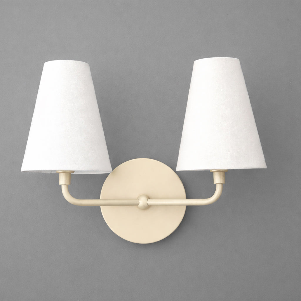 Two-bulb wall sconce with beige round metal base and white tapered fabric shades. - SCONCE MODEL NO. 1315