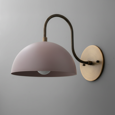 Wall sconce with curved antique brass arm and mauve dome-shaped metal shade mounted on round brass base. - SCONCE MODEL NO. 9092