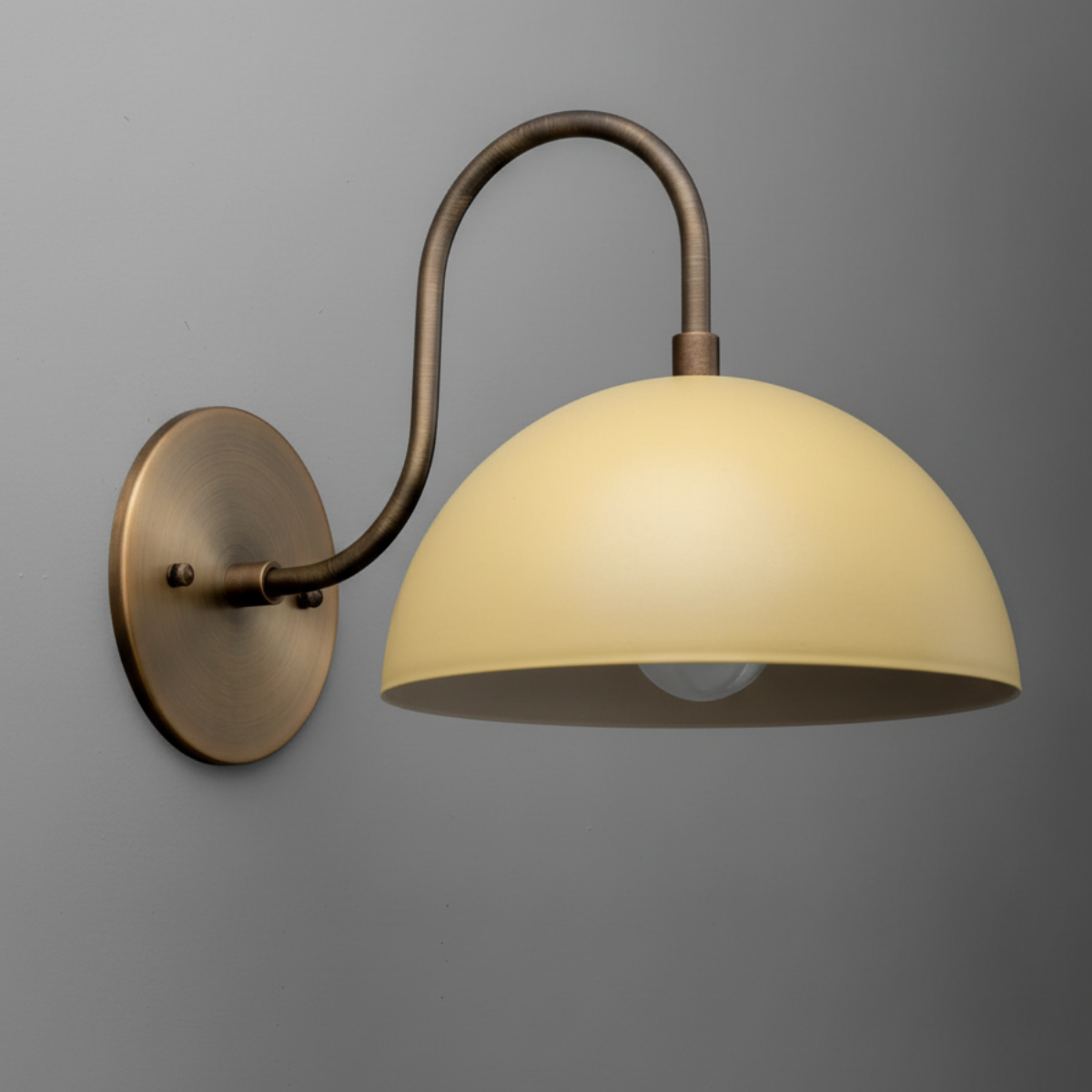 Antique brass wall sconce with curved arm and cream dome-shaped shade. - SCONCE MODEL NO. 9092