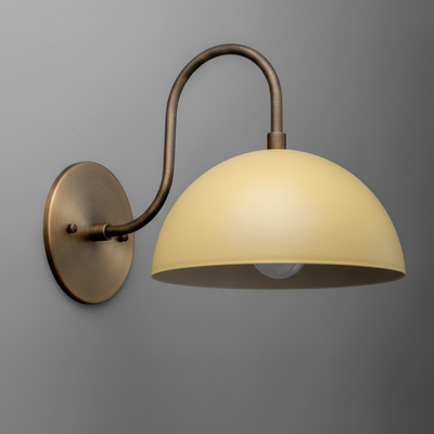 Antique brass wall sconce with curved arm and cream dome-shaped shade. - SCONCE MODEL NO. 9092