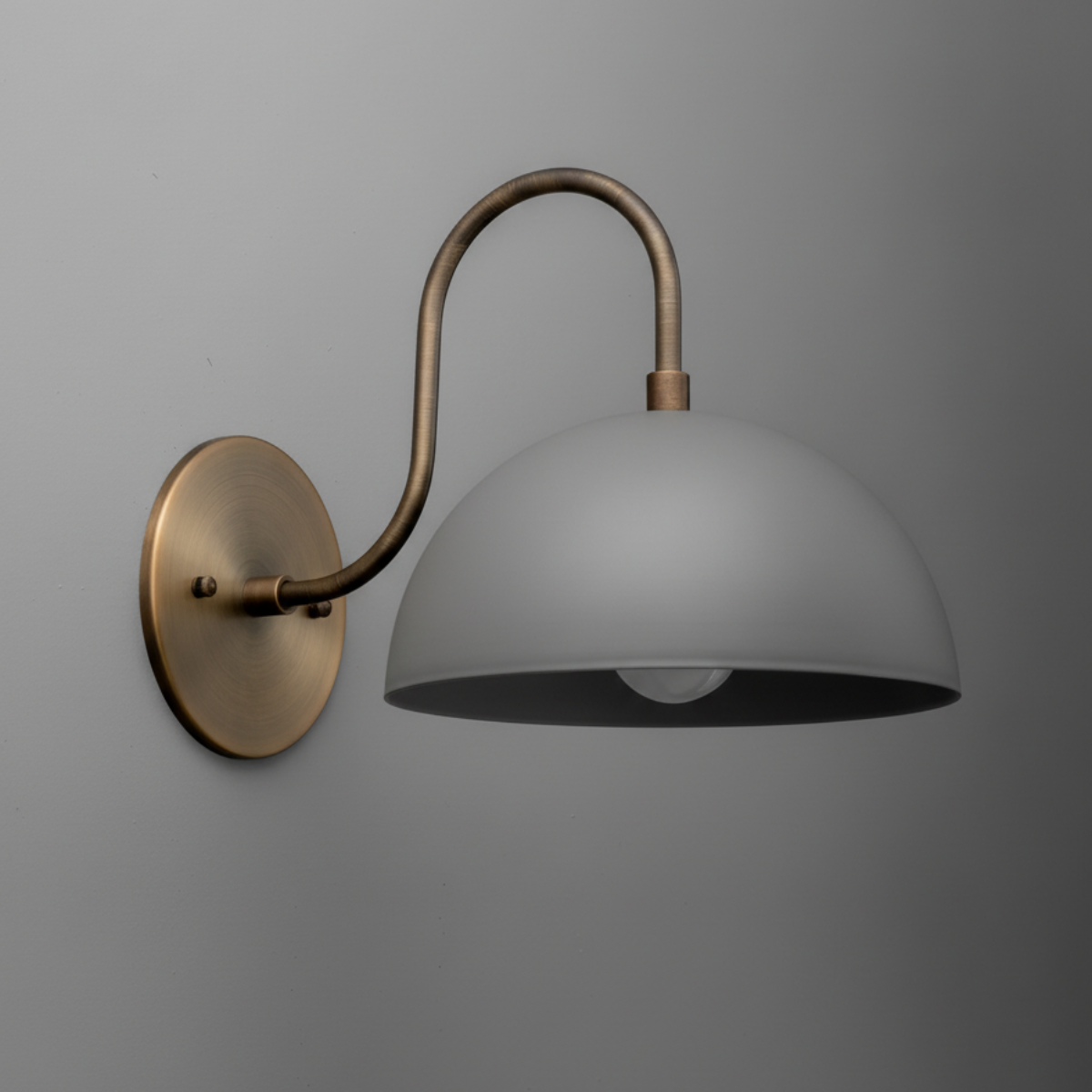 Wall-mounted sconce with antique brass curved arm and matte gray dome shade. - SCONCE MODEL NO. 9092