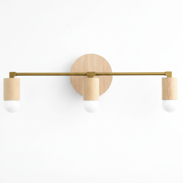 Three-bulb vanity light with raw brass bar and round beechwood mounts. - VANITY LIGHT MODEL NO. 4446