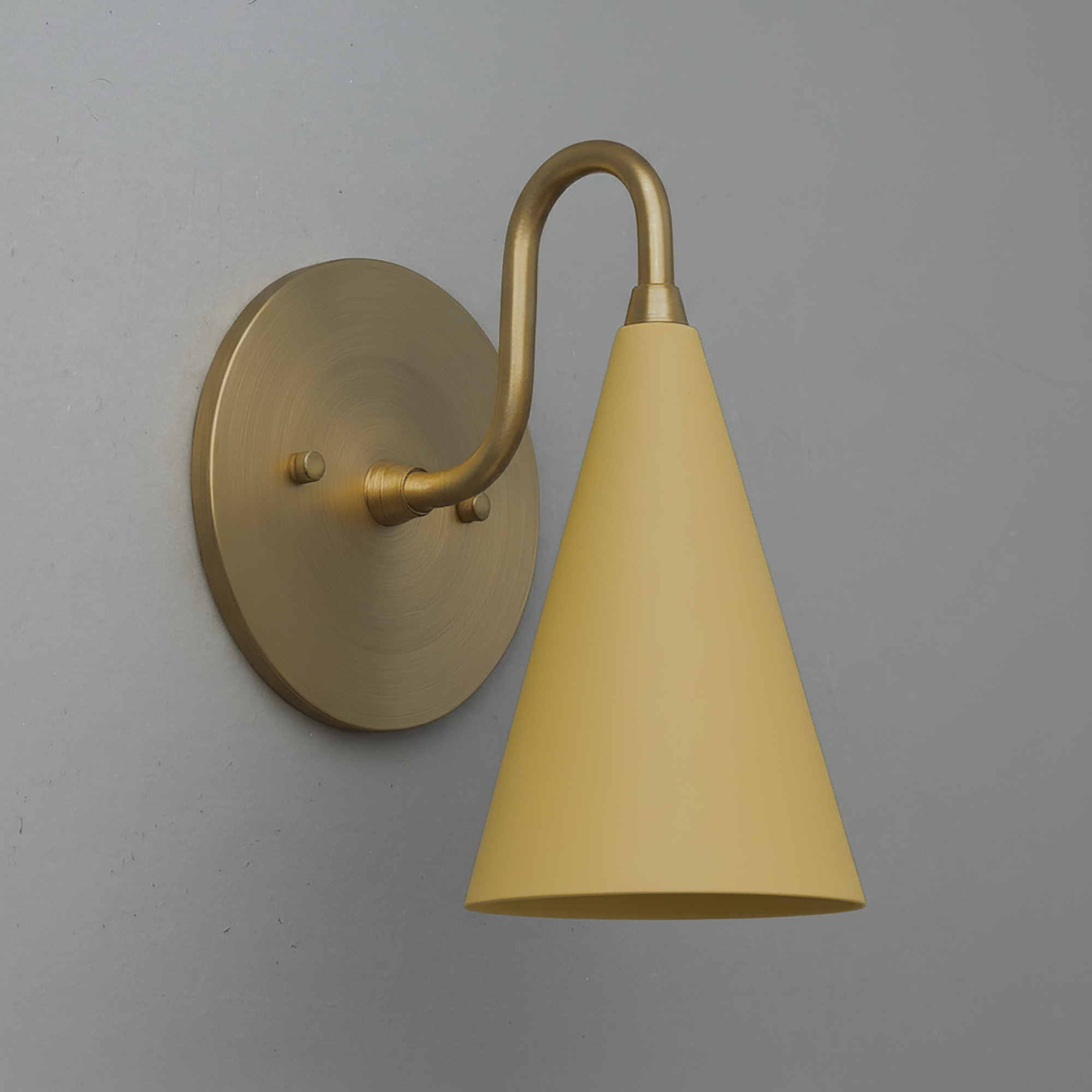 Antique brass wall sconce with matte yellow conical shade and curved arm. - Sconce Model No. 2900