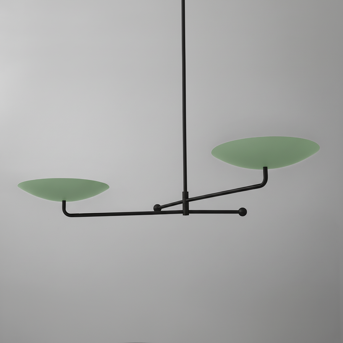 Modern black metal chandelier with two matte green disc-shaped shades on horizontal arms. - CHANDELIER MODEL NO. 0680