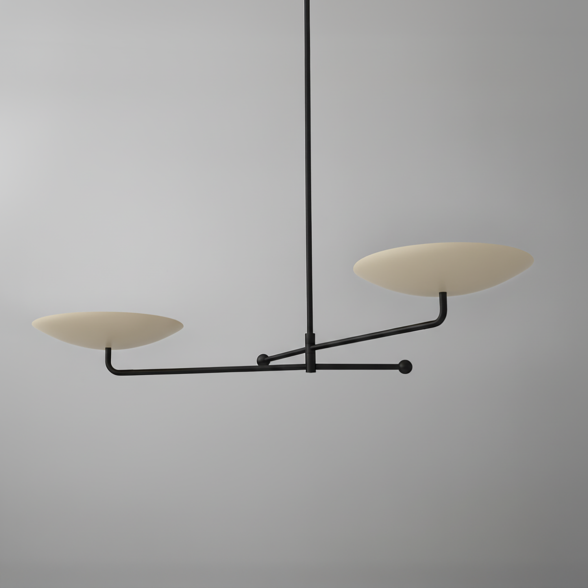 Black metal chandelier with two flat beige disc-shaped shades extending horizontally on separate arms. - CHANDELIER MODEL NO. 0680