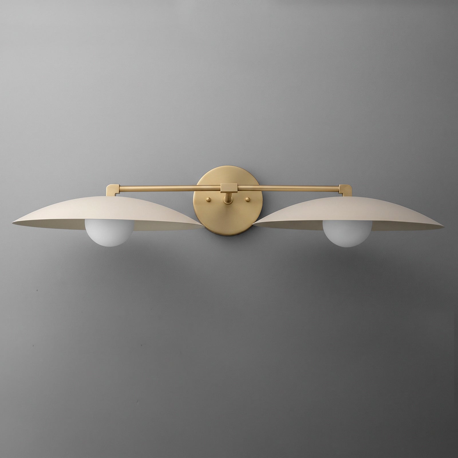 Brushed gold two-bulb vanity light with white dome-shaped shades and round wall mount. - VANITY LIGHT MODEL NO. 1168