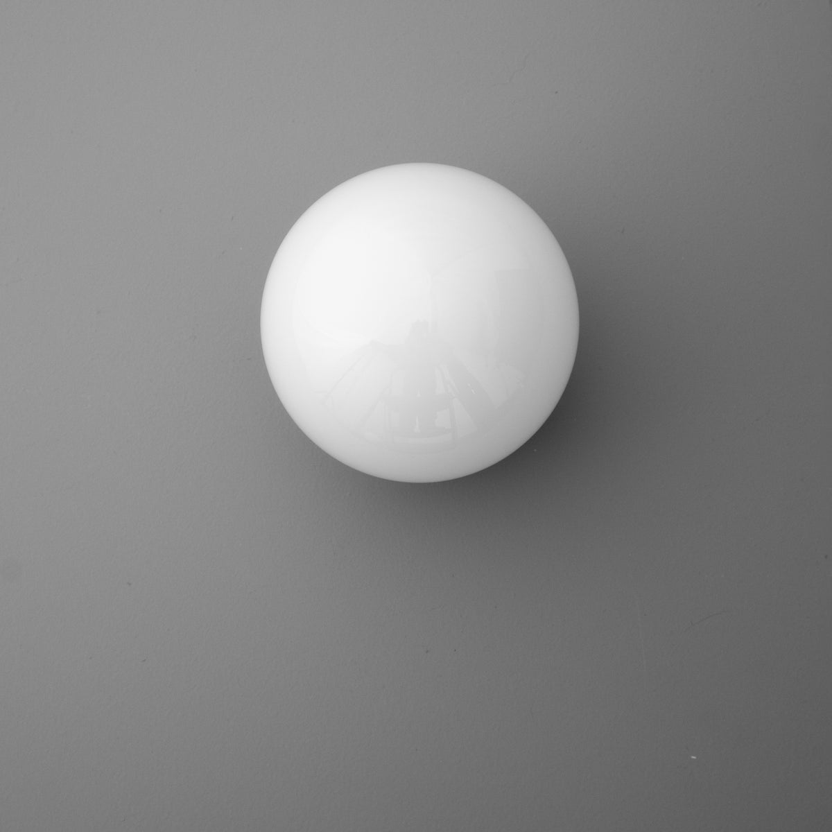 White spherical glass sconce shade with smooth matte finish against gray background. - SCONCE MODEL NO. 3825