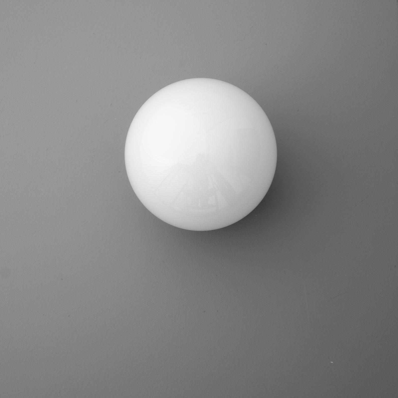 White spherical glass sconce shade with smooth matte finish against gray background. - SCONCE MODEL NO. 3825