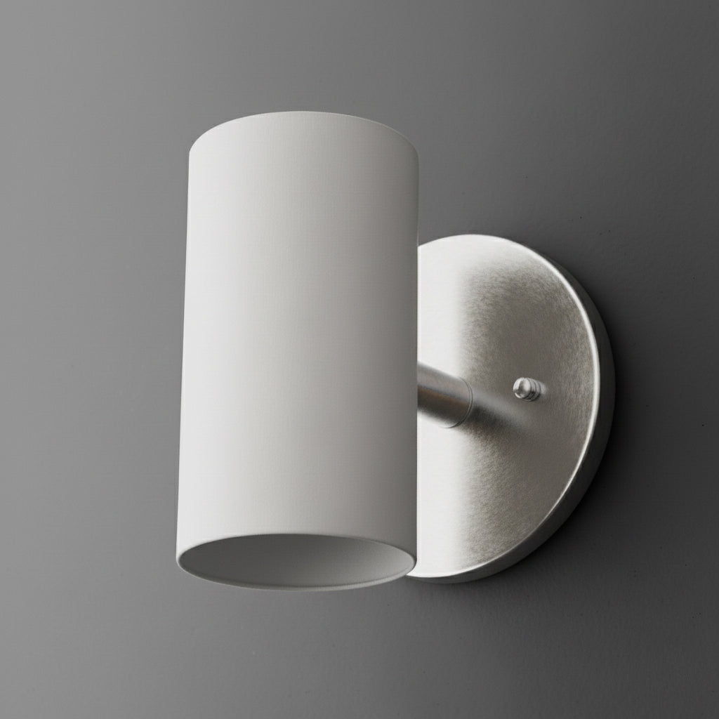 Cylinder sconce with a White shade on a short stem from a Brushed Nickel round wall plate. - SCONCE MODEL NO. 9697