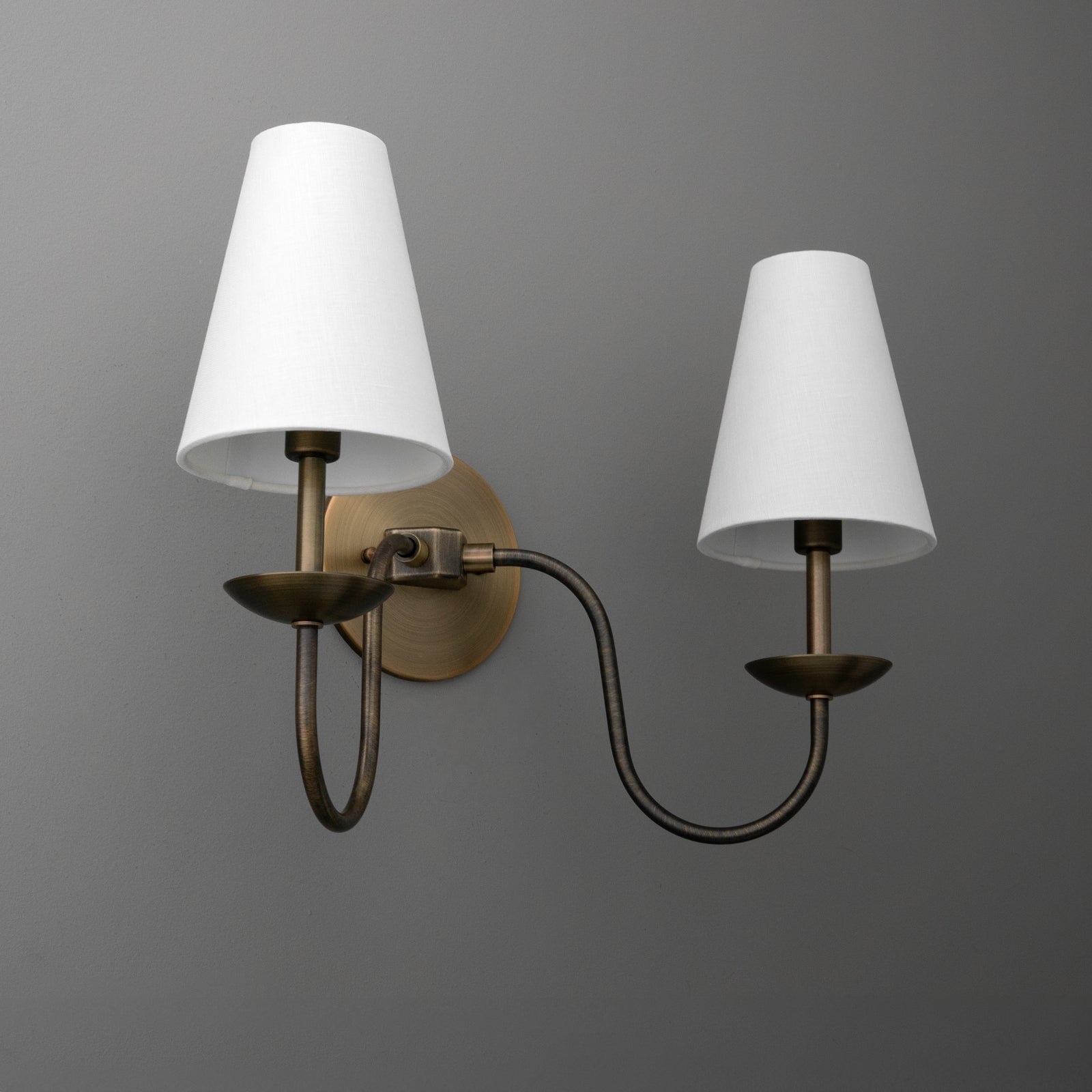 Two-bulb bronze wall sconce with curved arms and white tapered fabric shades. - SCONCE MODEL NO. 5846