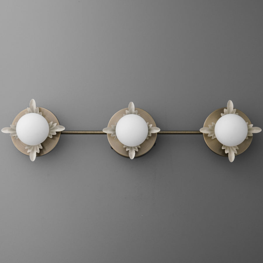 Three-bulb vanity light fixture with round white glass shades and brushed nickel finish on mounting plate and arms. - VANITY LIGHT MODEL NO. 1154