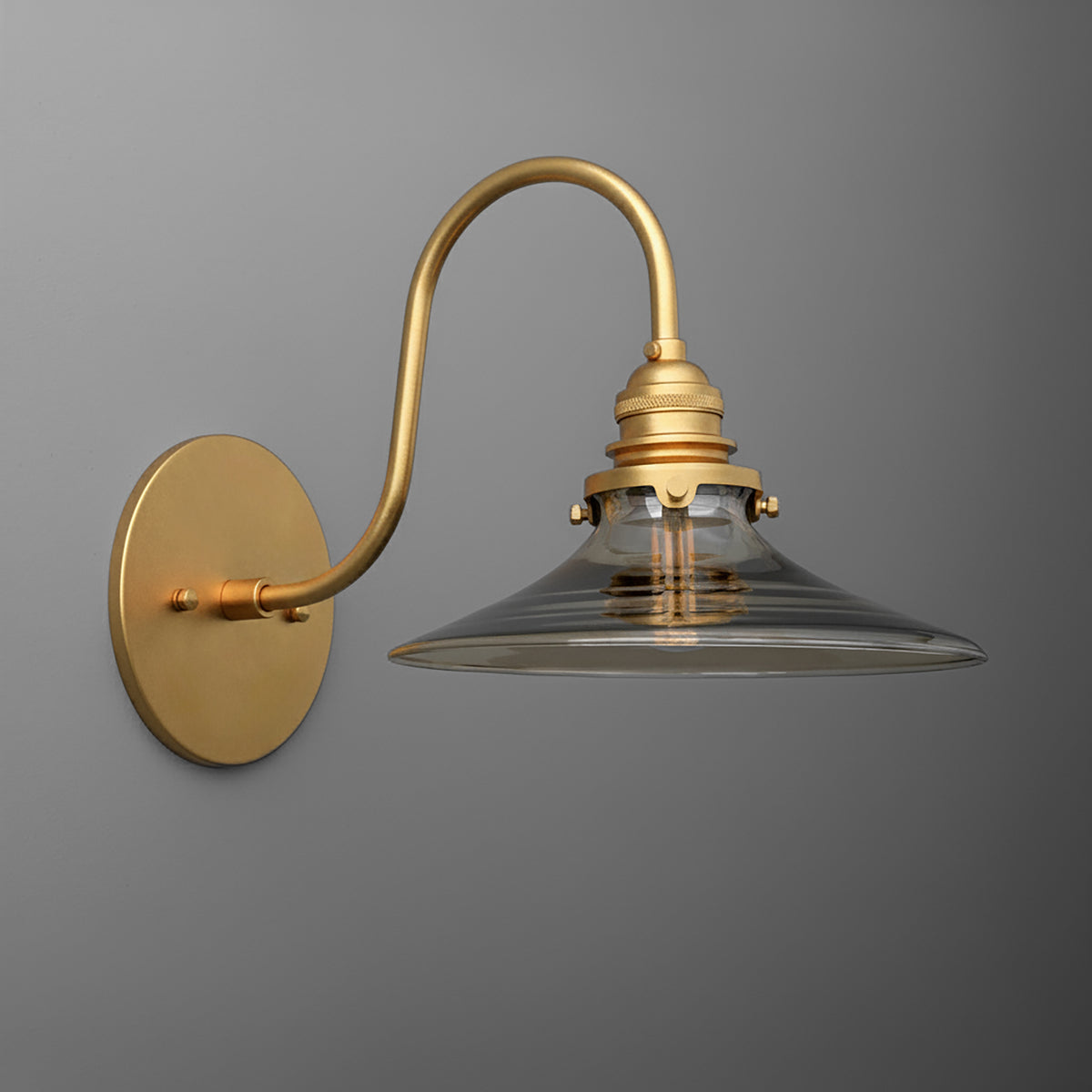 Brushed brass wall sconce with clear conical glass shade and curved arm design. - SCONCE MODEL NO. 3901