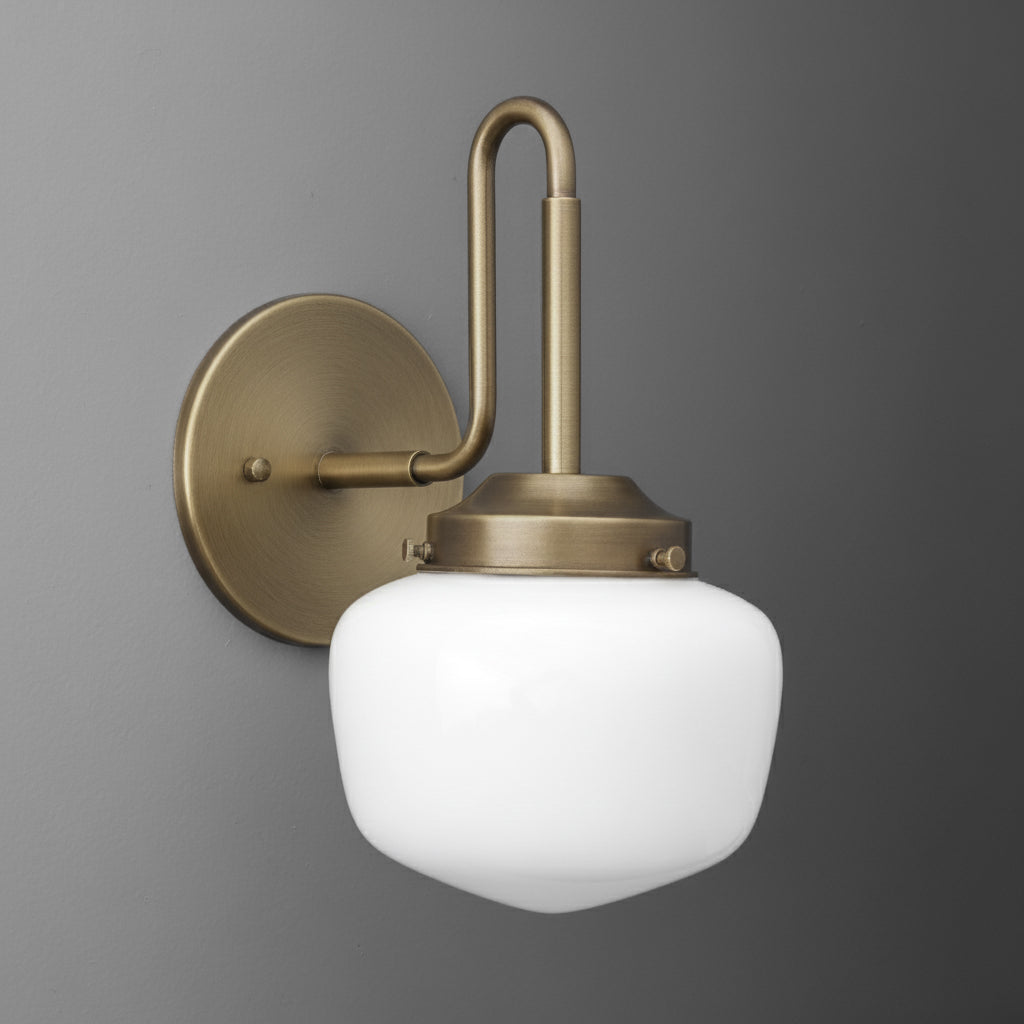 Wall sconce with brushed brass finish, curved arm, and frosted white glass shade. - SCONCE MODEL NO. 1020