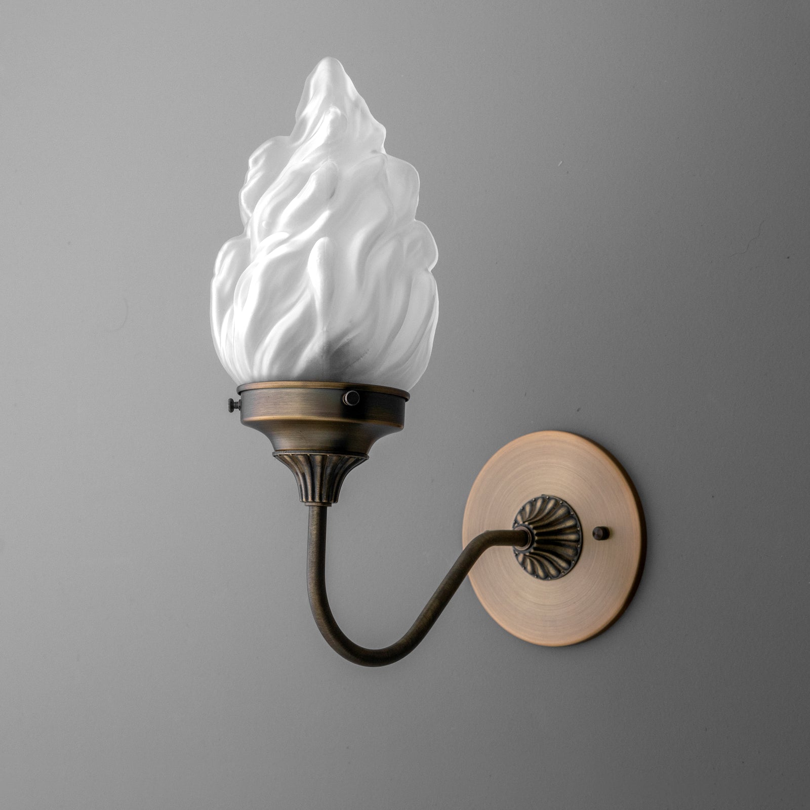 Wall sconce with bronze curved arm and flame-shaped frosted glass shade. - SCONCE MODEL NO. 1024