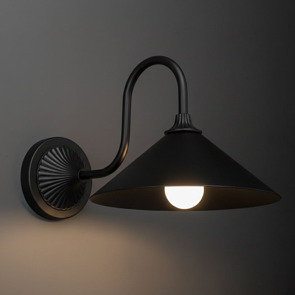 Black metal wall sconce with a round base, curved arm, and wide conical shade illuminating a bulb. - SCONCE MODEL NO. 1031