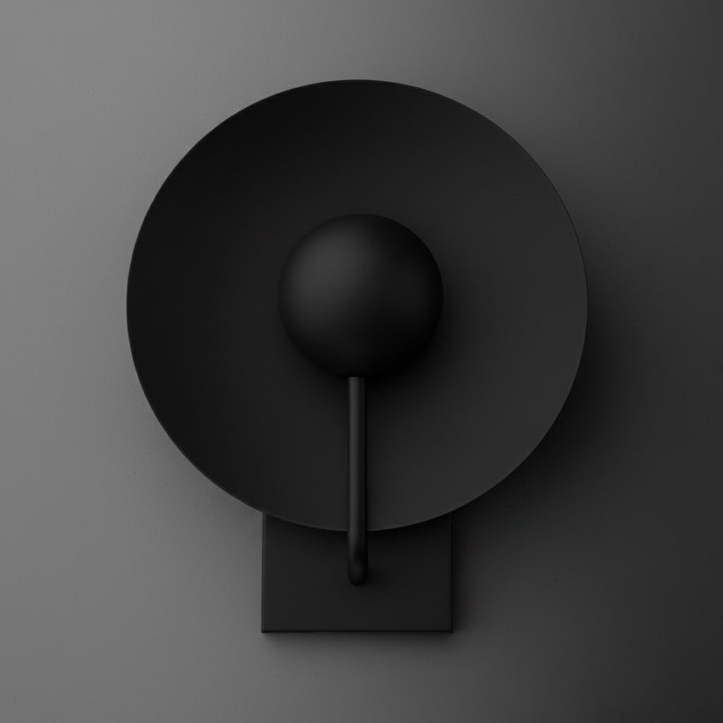Matte black metal wall sconce with a circular backplate and a single central bulb holder. - SCONCE MODEL NO. 7858