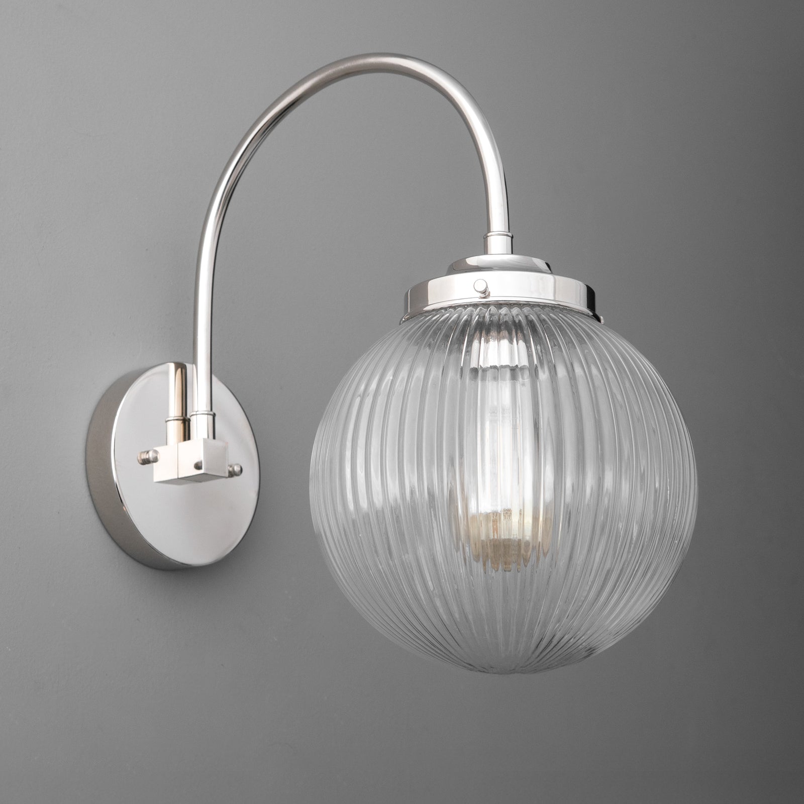 Polished nickel wall sconce with ribbed glass globe shade and curved arm on round backplate. - SCONCE MODEL NO. 8763