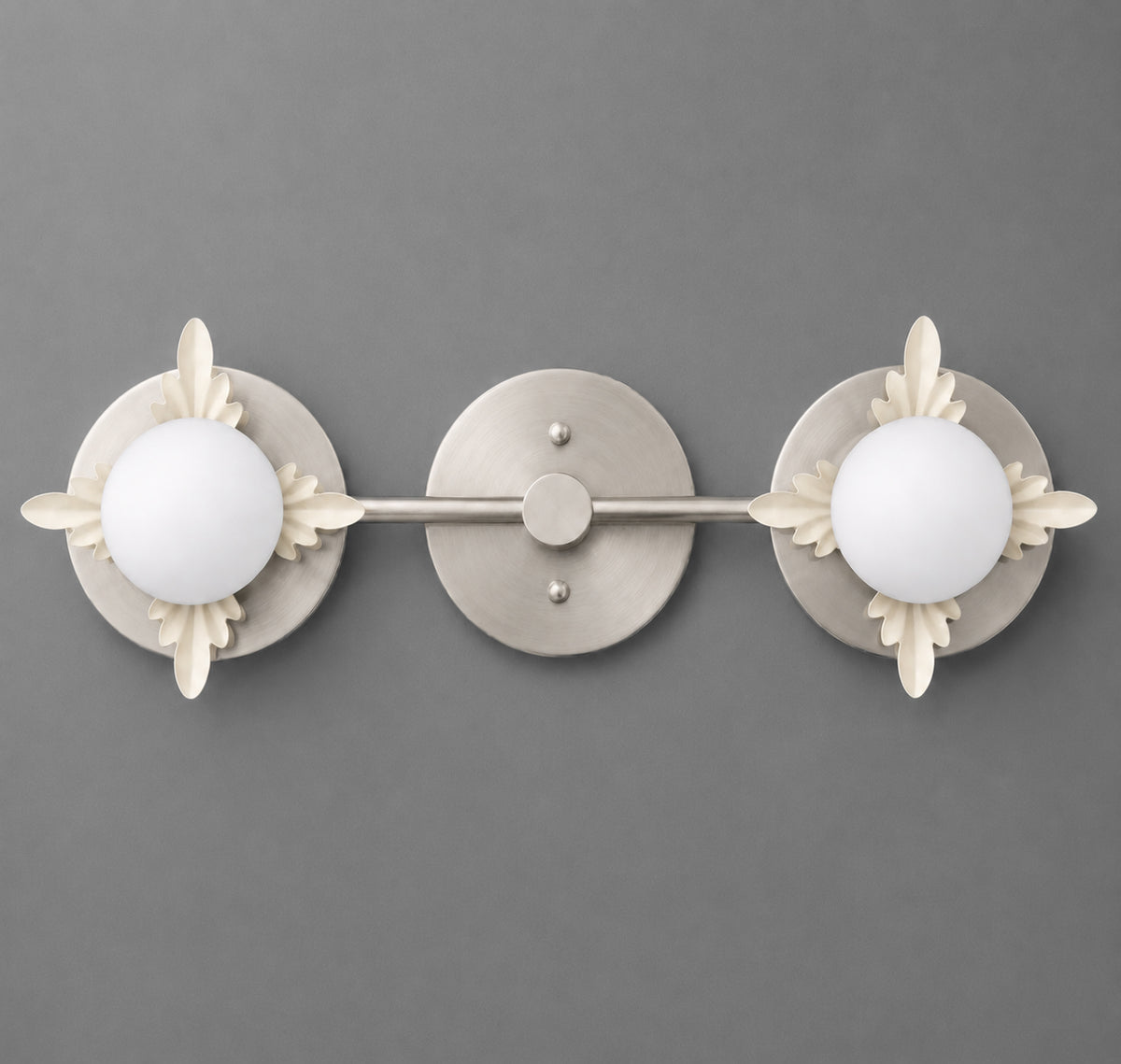 Two-light vanity light in Brushed Nickel with Cream leaf accents around opal glass globes on round backplates joined by a straight bar. - VANITY LIGHT MODEL NO. 1118