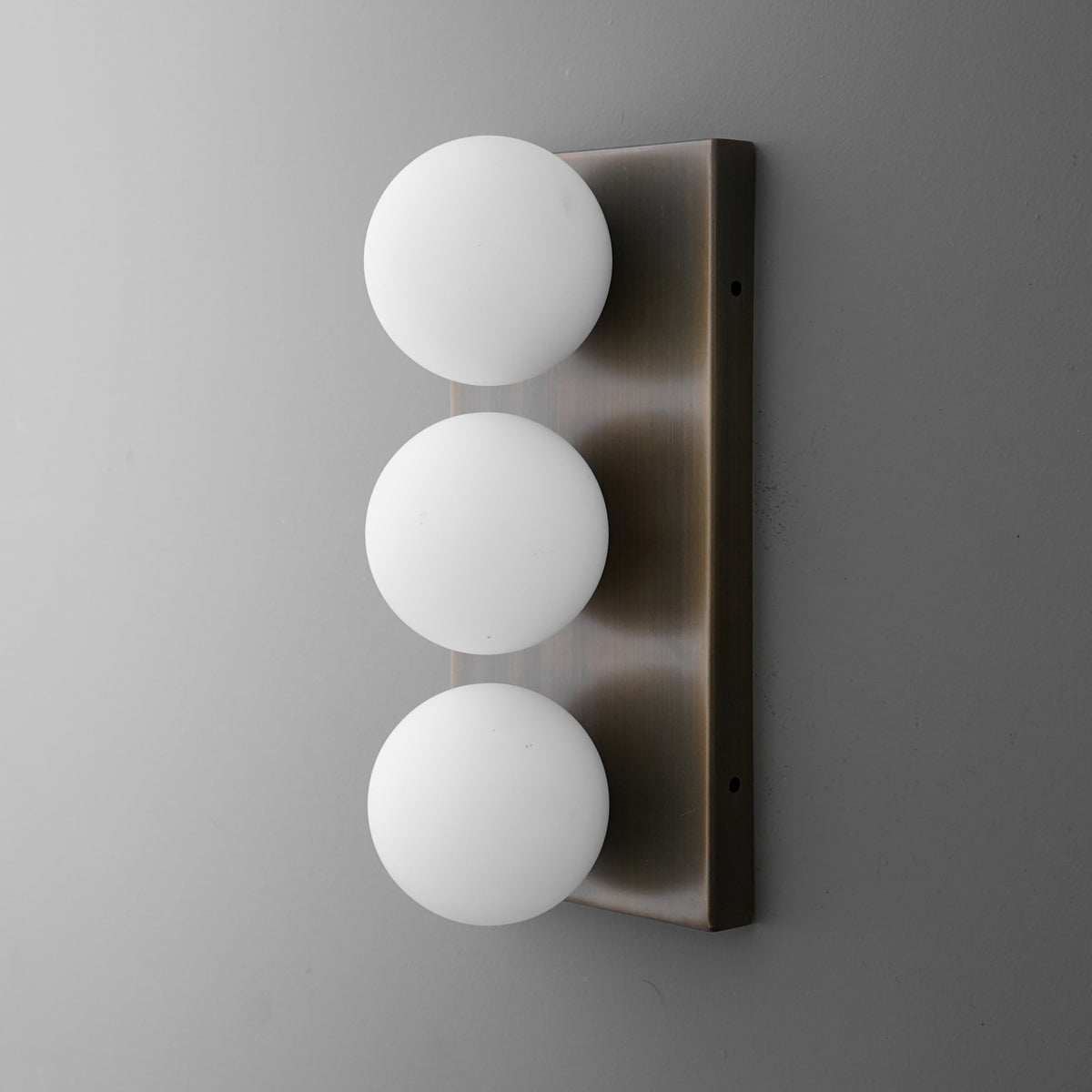 Modern wall sconce with three evenly spaced white frosted glass globes on a brushed metal rectangular base. - SCONCE MODEL NO. 2623