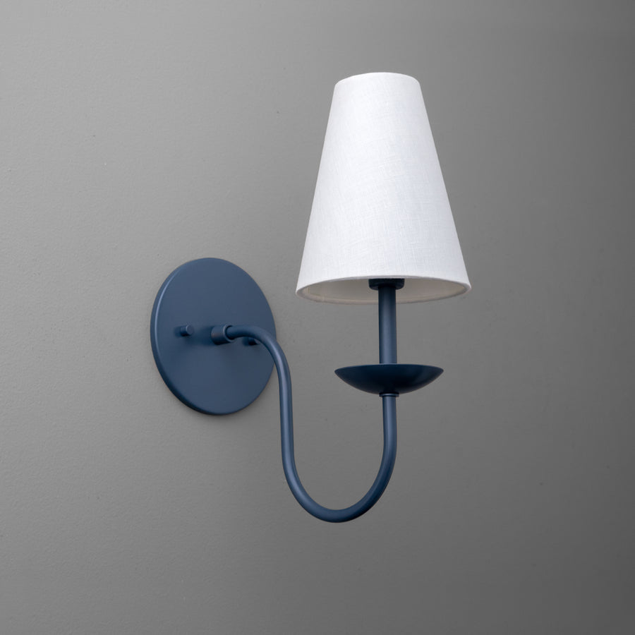 Wall sconce with curved coal blue metal arm and round base, white fabric tapered shade. - SCONCE MODEL NO. 7085