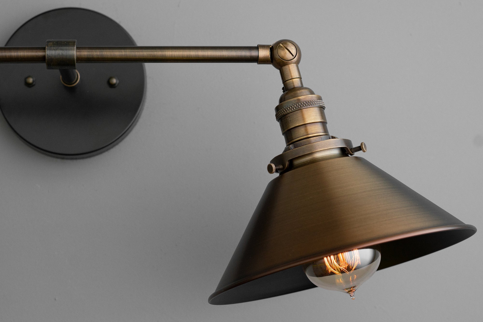 Industrial-style vanity light with antique brass finish and conical metal shade. - VANITY LIGHT MODEL NO. 1861