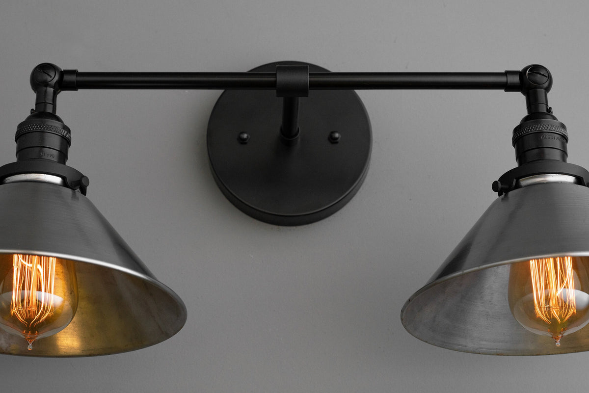Black industrial two-bulb vanity light with metal shades and exposed filament bulbs. - VANITY LIGHT MODEL NO. 0799