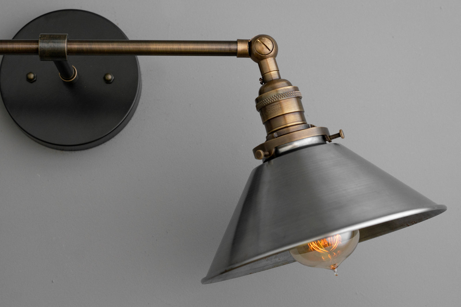 Industrial-style black metal vanity light with conical shade and exposed bulb. - VANITY LIGHT MODEL NO. 0799