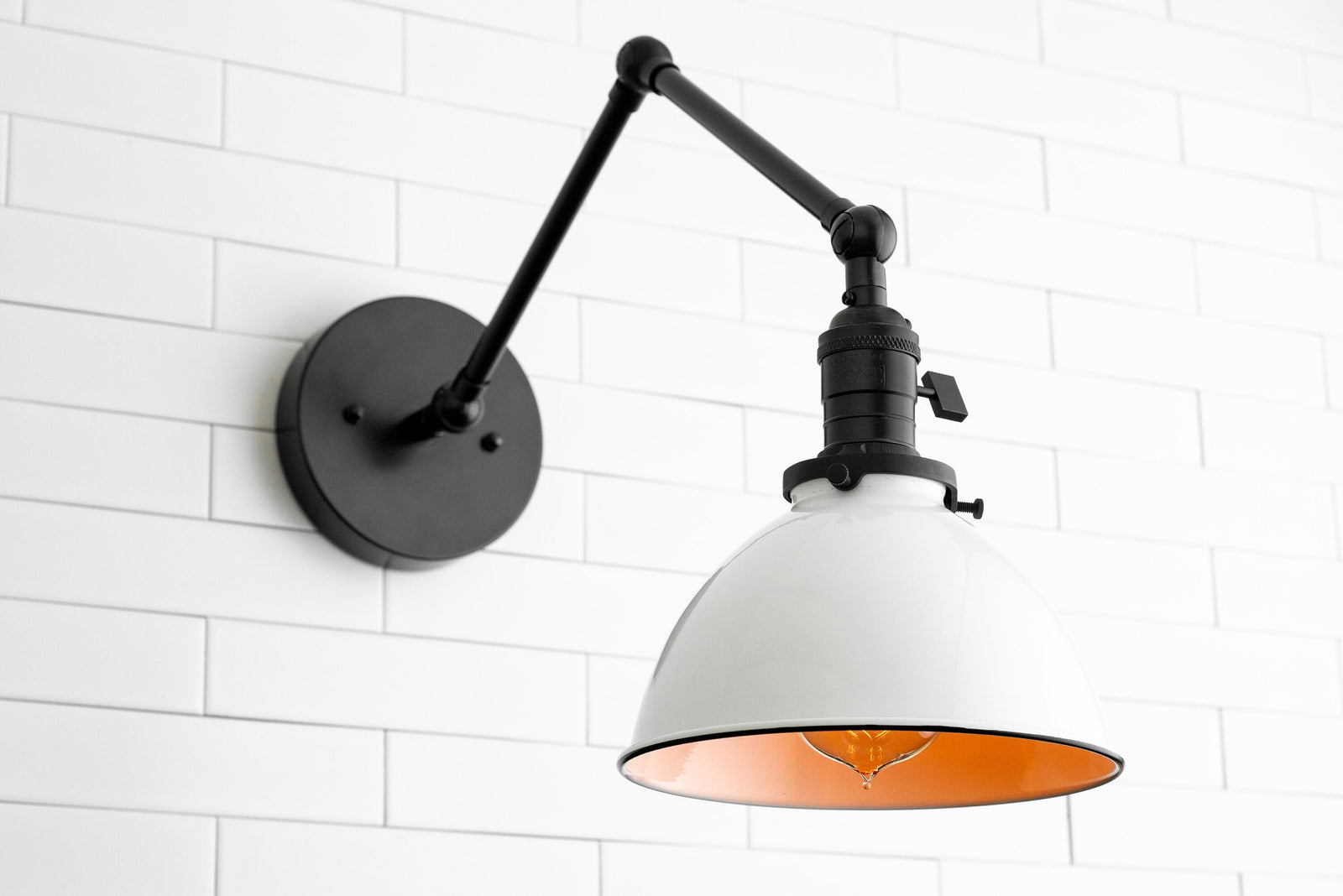 Industrial-style adjustable wall sconce in black with white metal shade and exposed bulb. - SCONCE MODEL NO. 8551
