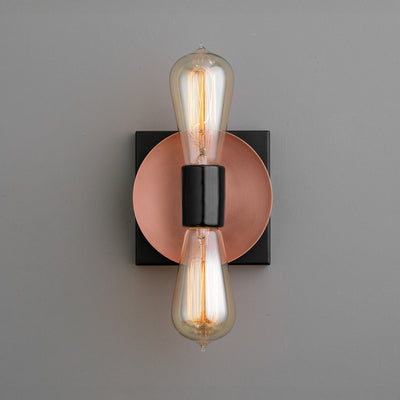 Industrial-style wall sconce with exposed vintage filament bulbs, copper backplate, and black accents. - SCONCE MODEL NO. 8169