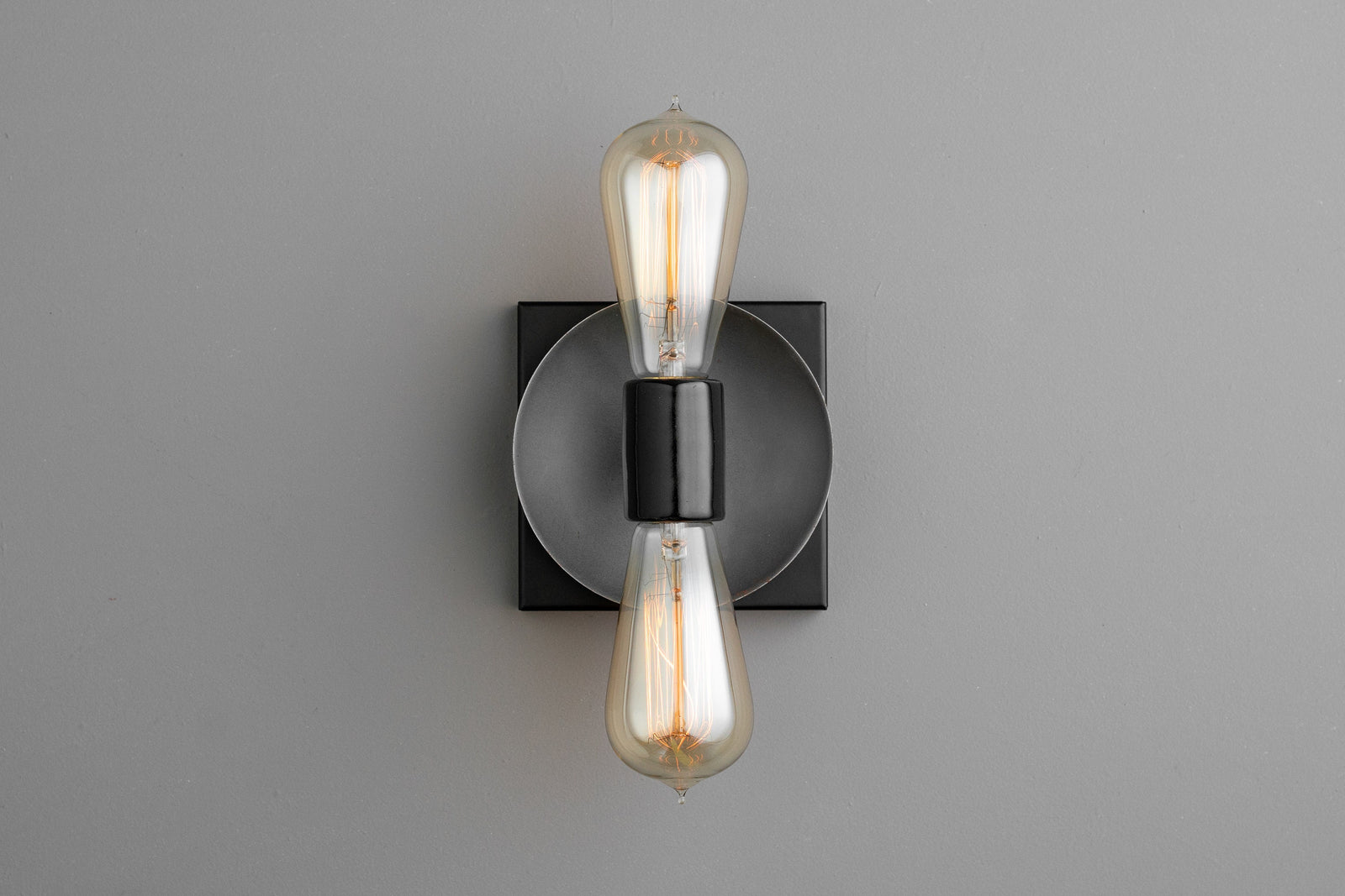 Industrial-style black metal sconce with exposed vintage-style filament bulbs in vertical arrangement. - SCONCE MODEL NO. 8169
