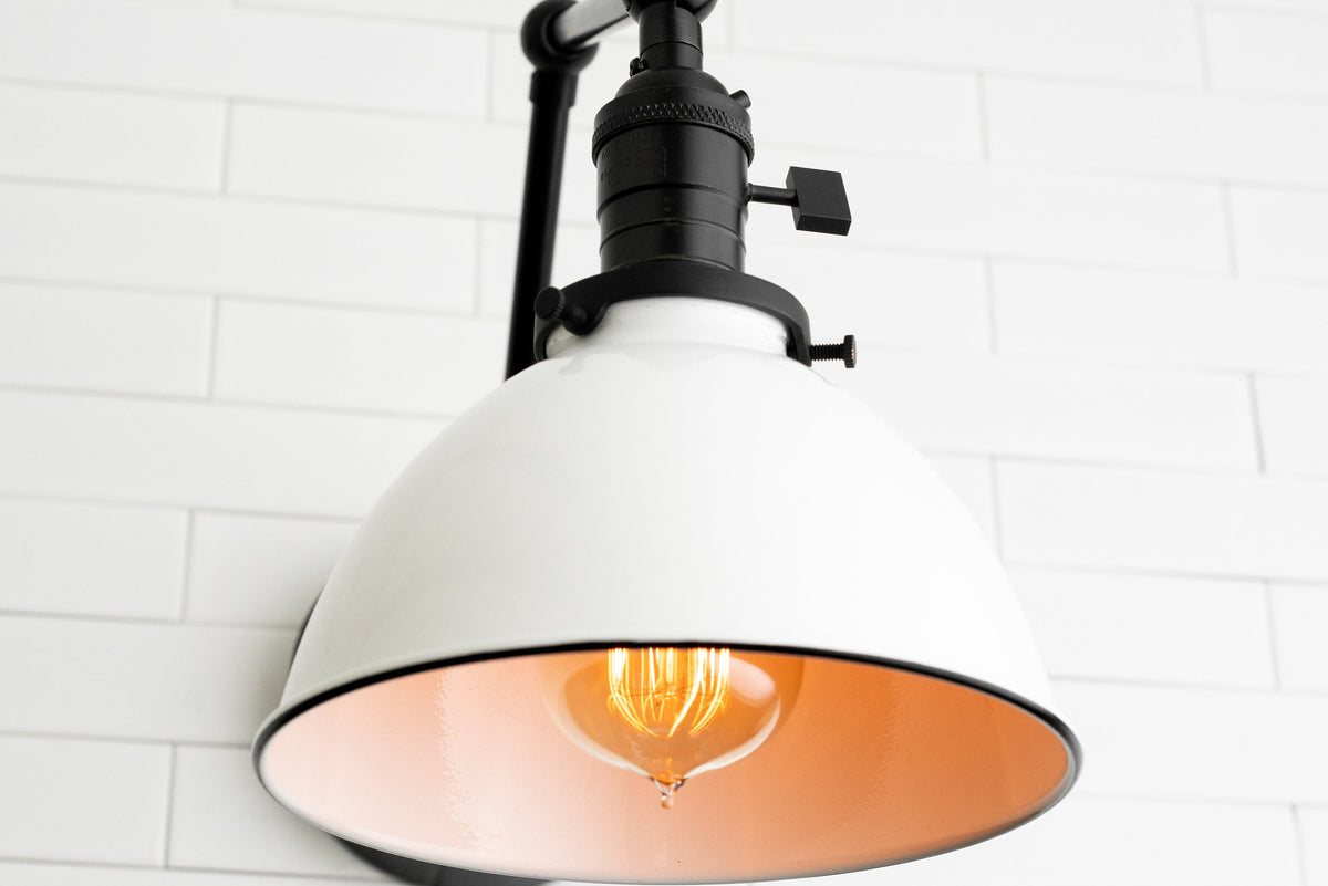 Adjustable white metal industrial sconce with black trim and exposed filament bulb. - SCONCE MODEL NO. 8551