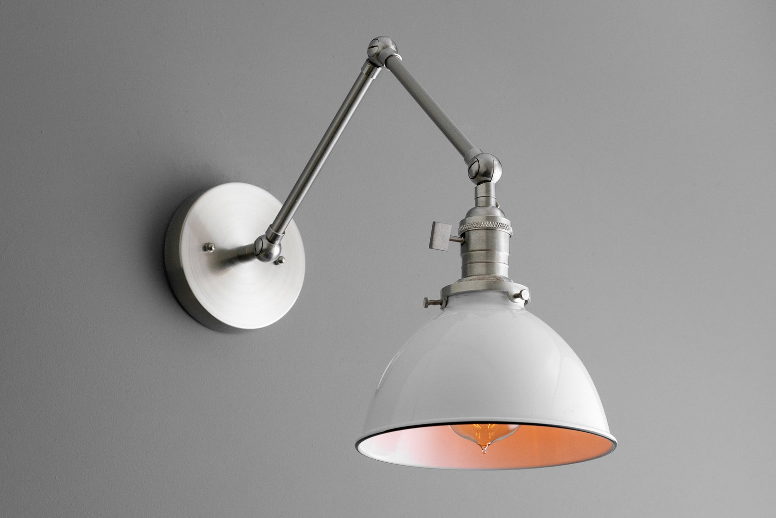 Adjustable industrial wall sconce with white conical shade and brushed nickel finish on mounting arm and wall plate. - SCONCE MODEL NO. 8551