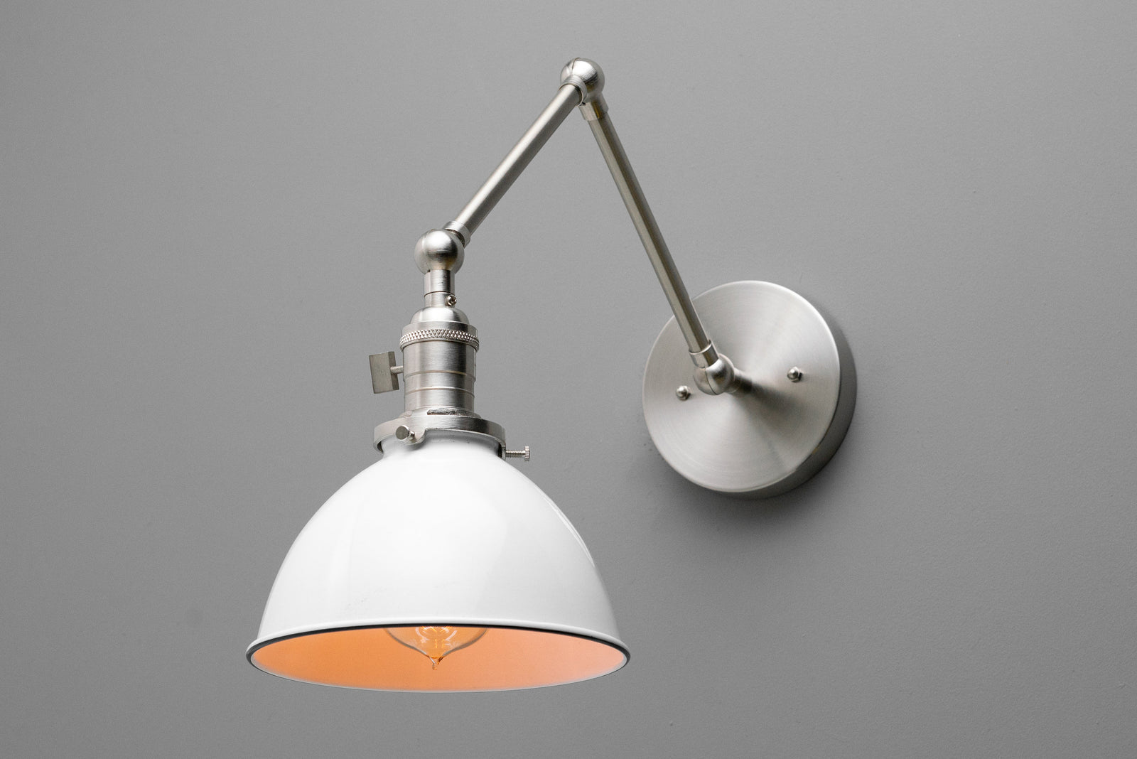 Adjustable industrial-style wall sconce with white metal shade and brushed nickel finish. - SCONCE MODEL NO. 8551