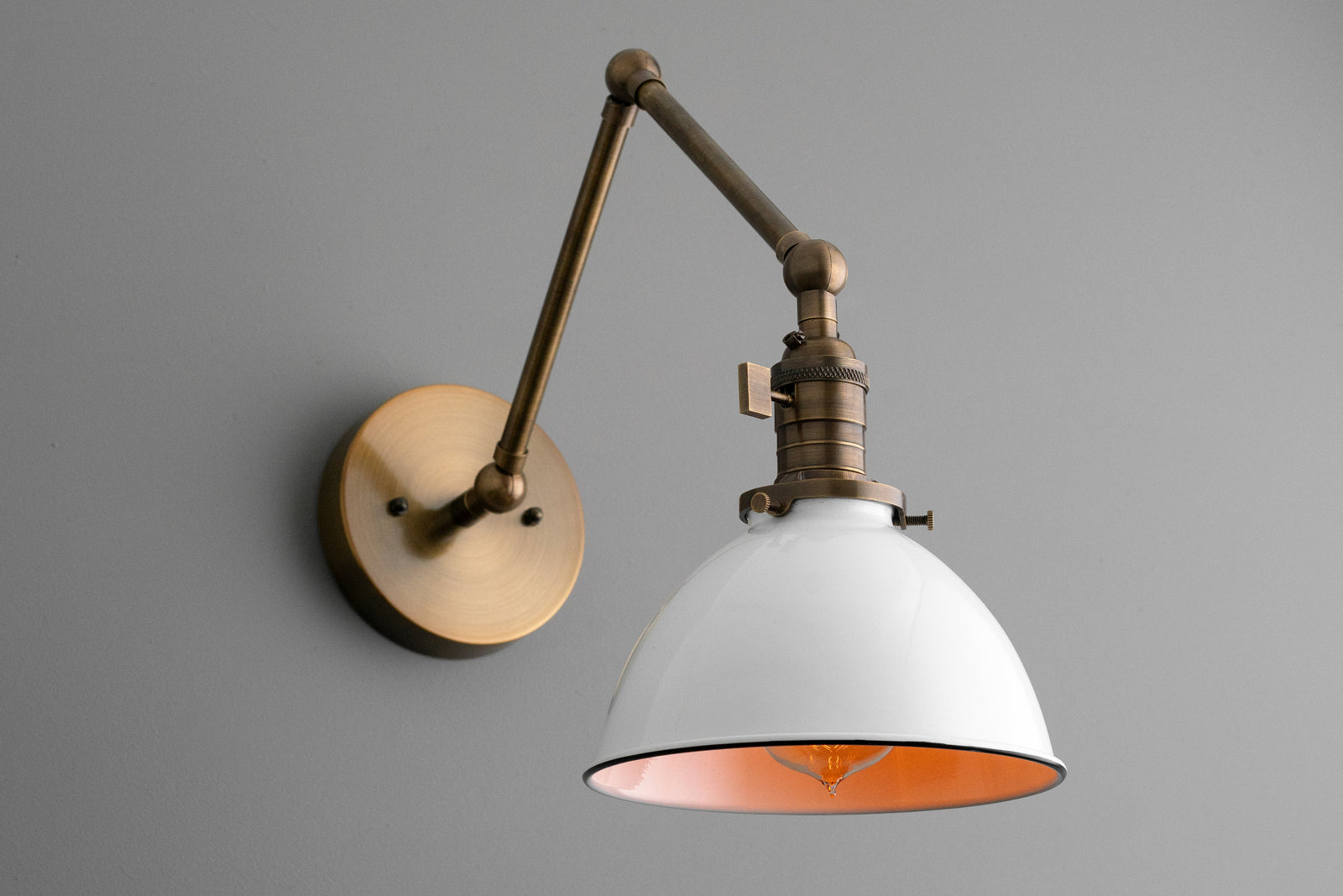 Adjustable antique brass industrial wall sconce with white dome shade and copper interior. - SCONCE MODEL NO. 8551