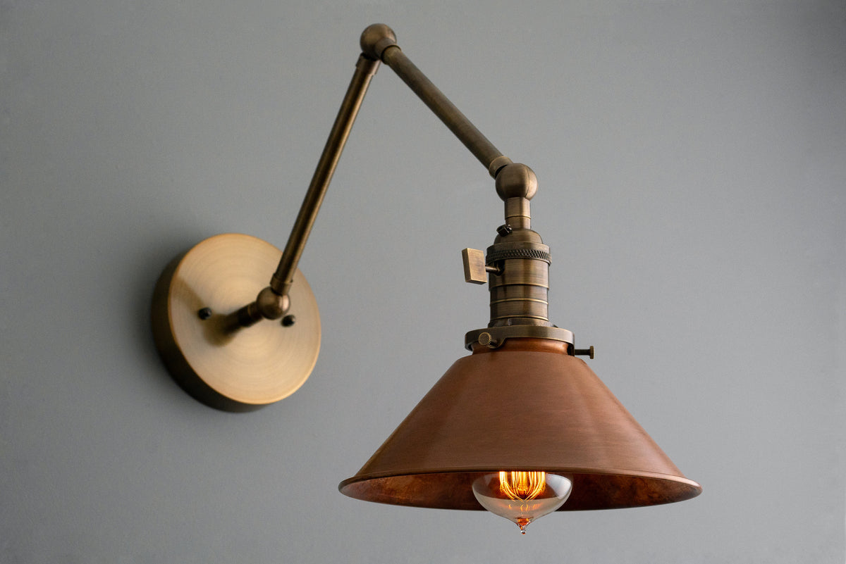 Industrial adjustable wall sconce with antique brass finish and conical metal shade. - SCONCE MODEL NO. 6668