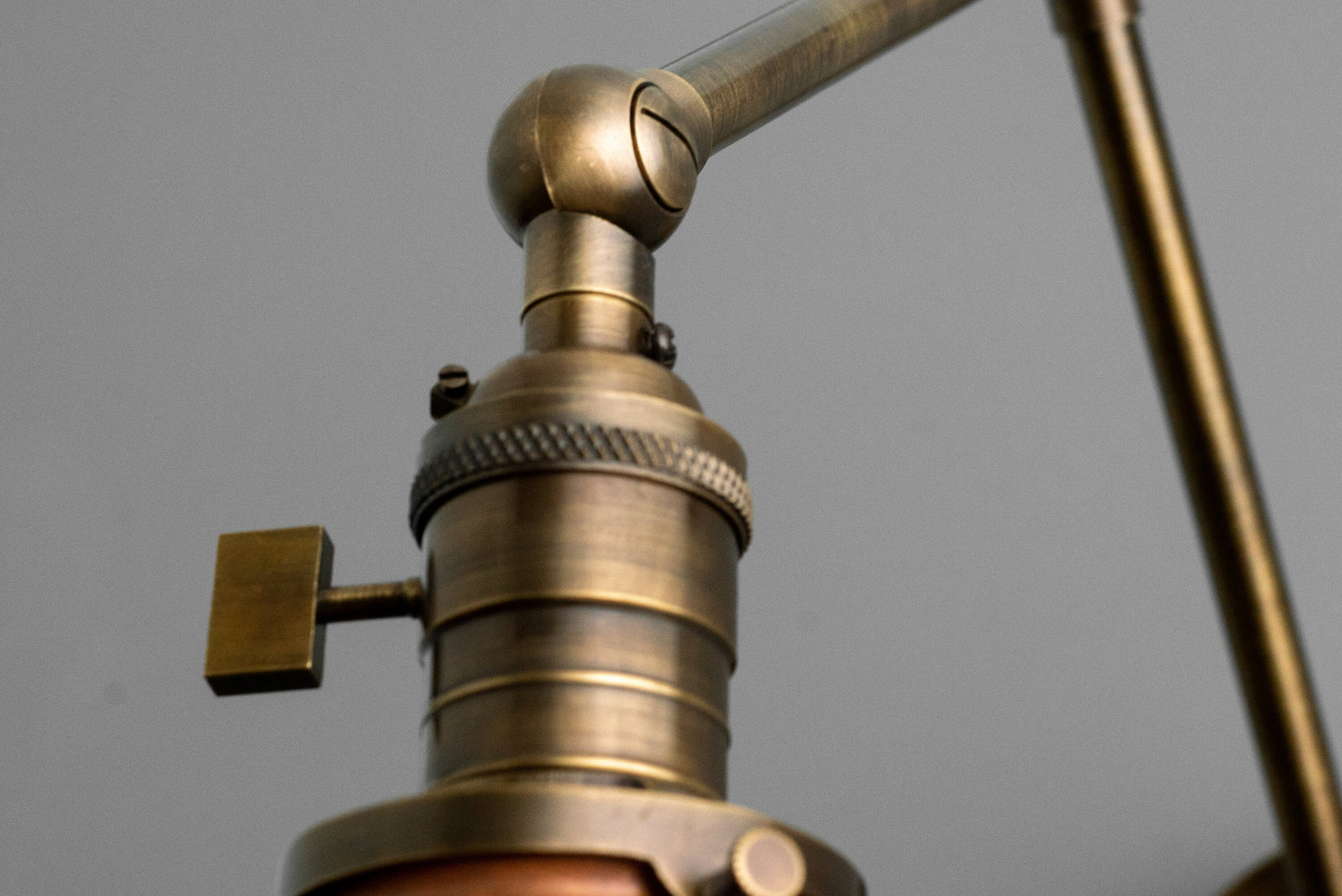 Adjustable antique brass industrial sconce fixture with detailed knurled metal accents and copper shade. - SCONCE MODEL NO. 6668