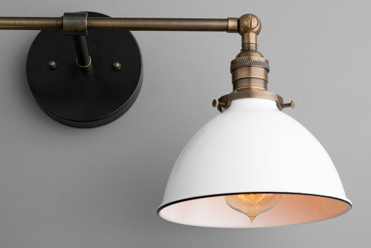 Industrial-style vanity light with white metal shade and antique brass arm and wall mount. - VANITY LIGHT MODEL NO. 4564