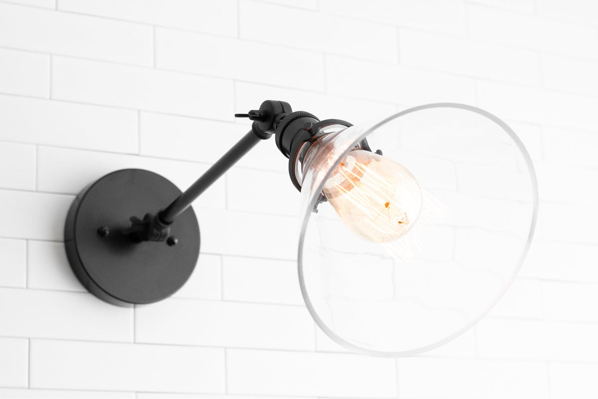 Adjustable industrial wall sconce with black metal arm and clear glass shade, exposed vintage bulb. - SCONCE MODEL NO. 7962
