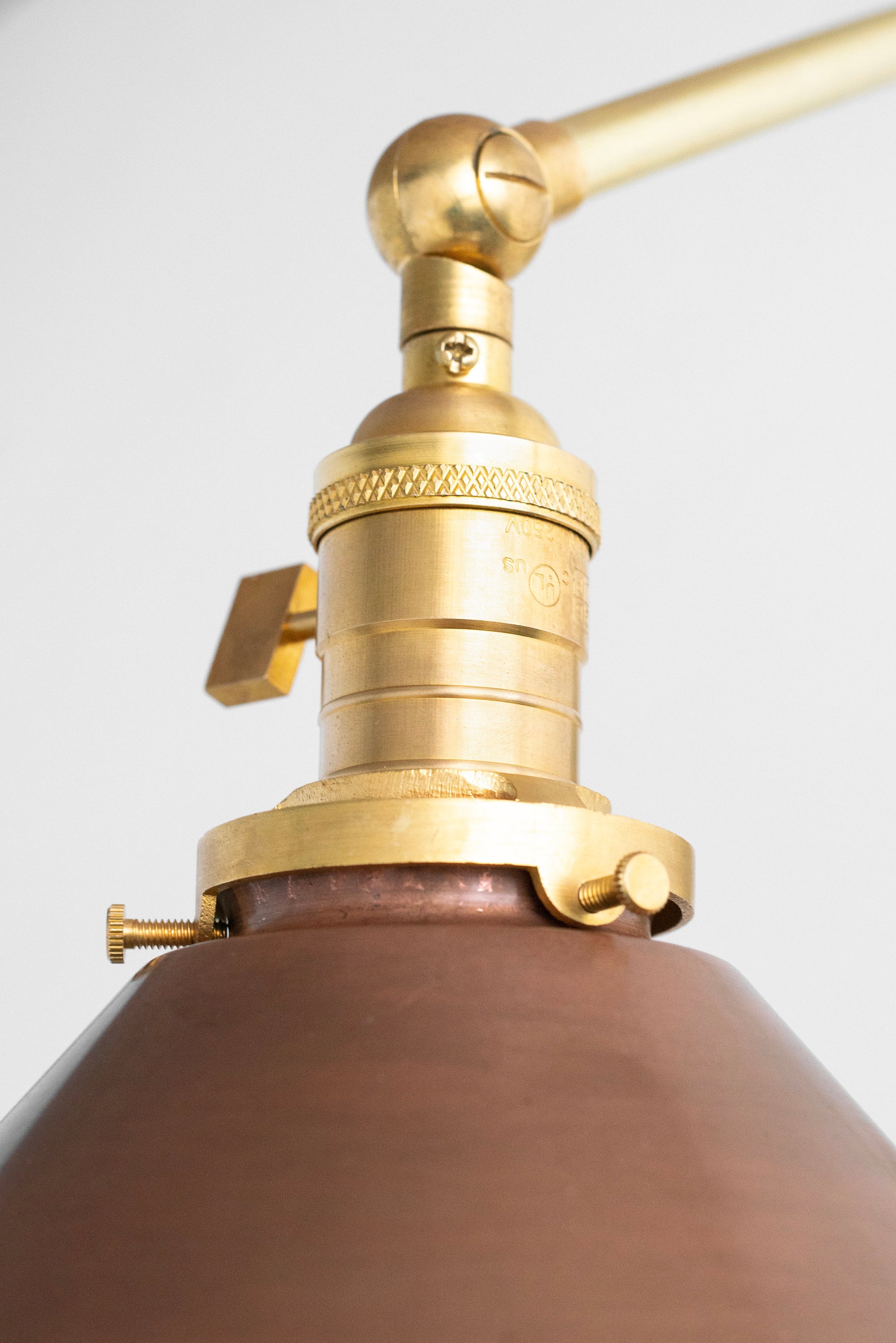 Adjustable mid-century modern sconce in raw brass with brown shade and industrial detailing. - SCONCE MODEL NO. 6668