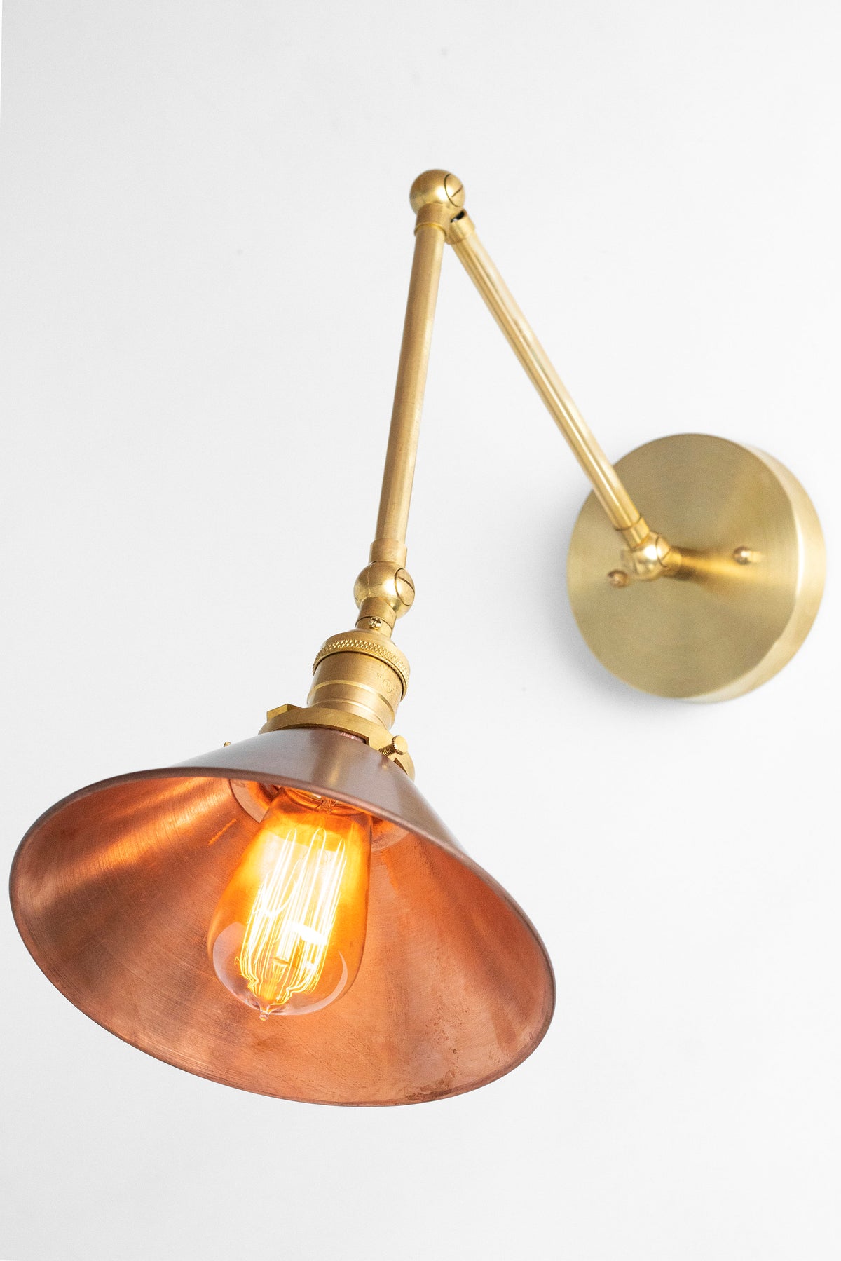 Adjustable raw brass industrial sconce with exposed bulb and wide copper shade. - SCONCE MODEL NO. 6668