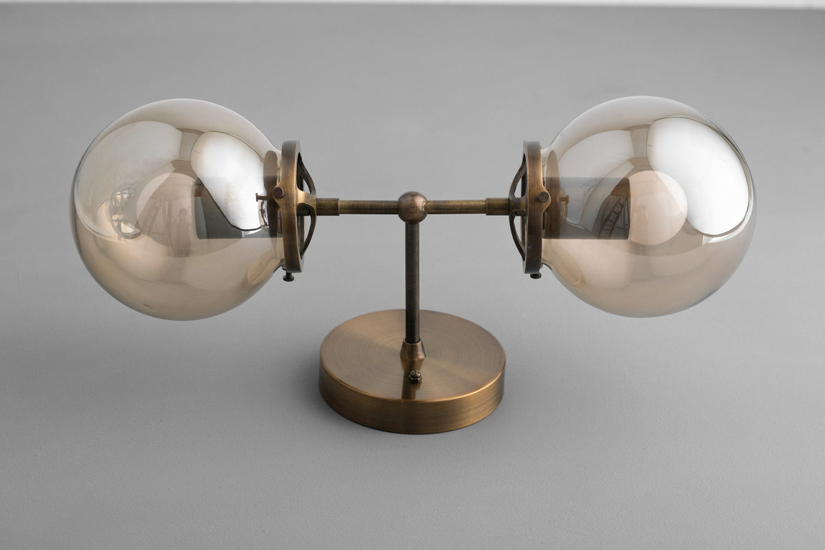 Mid-century modern vanity light with two clear globe bulbs and antique brass finish. - VANITY LIGHT MODEL NO. 8983